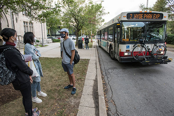 Students gather outside a CTA bus on campus